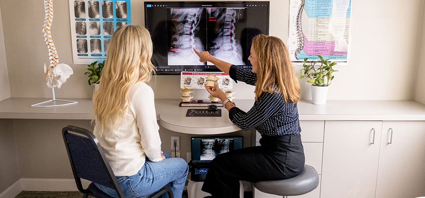 chiropractor discussing auto accident injuries with patient